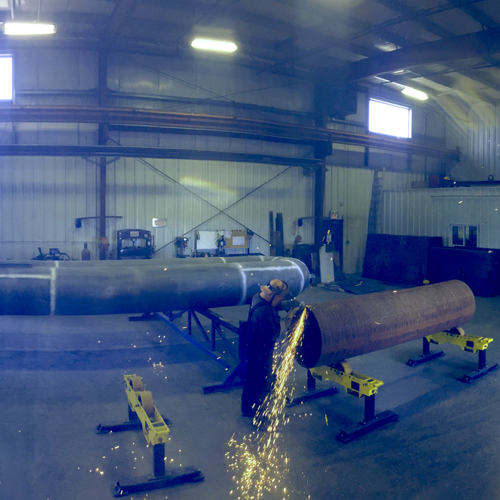 A large pipe sitting in the middle of an industrial building.