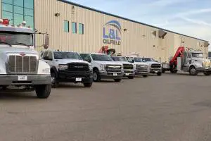 A row of trucks parked in front of a building.