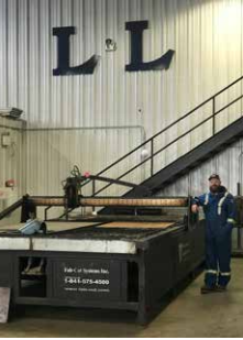 A man standing next to an industrial machine.